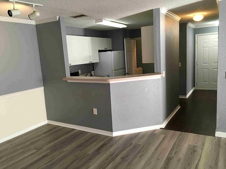Dinner area with new installed Vinyl plank floor along with kitchen, washer/dryer and hallway