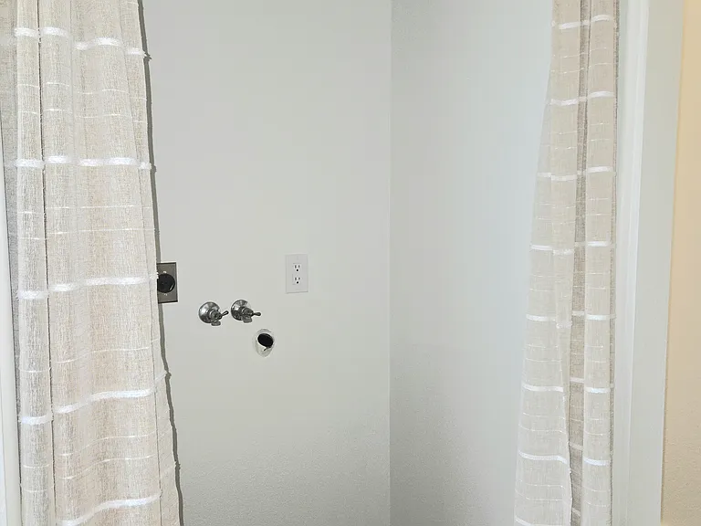 Laundry room built for use with a stacking washer/dryer. (Not supplied) Curtains not included.