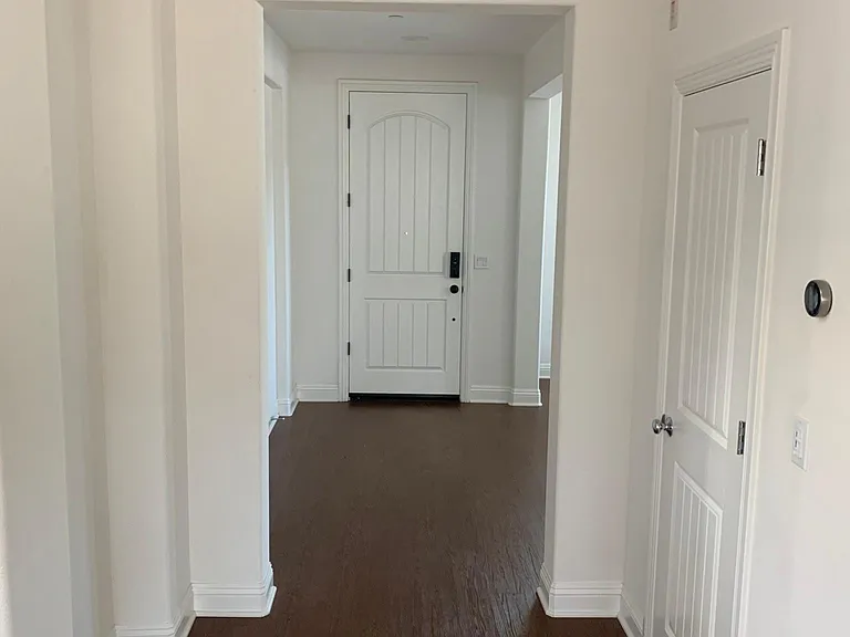 Front door hallway from kitchen view