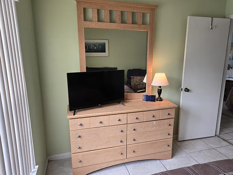 GUESTROOM INCLUDES A DRESSER AND FEATURES A LARGE CLOSET WTH DOUBLE SLIDING DOORS