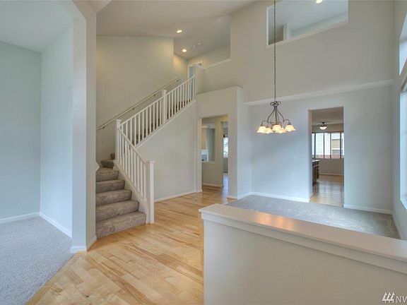 Vaulted ceilings and hardwoods greet you as you enter this home!