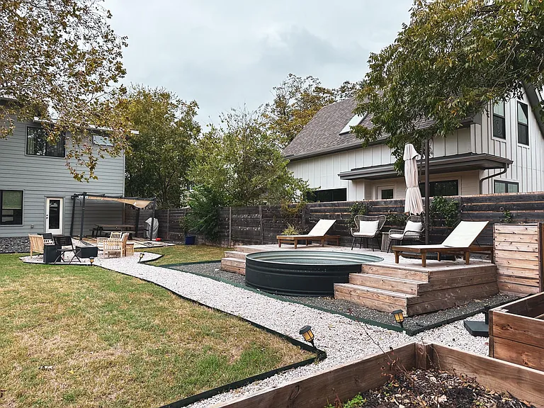 Stock tank pool and backyard area
