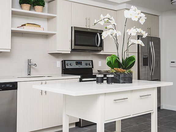 Gorgeous finishes include quartz counters and wood plank-style flooring