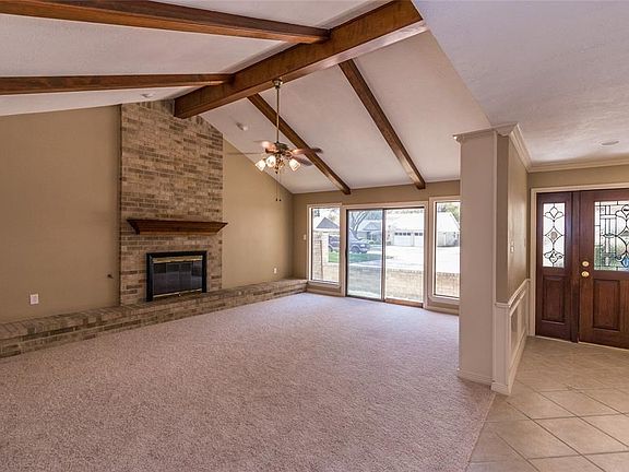 When you enter the home through the lead glass front door you will also turn and enter the Large Family Room.  The Family Room boasts built ins, a gas fireplace, vaulted ceilings with wood beams.  There is a sliding door out to the front atrium area.  New