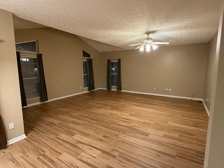 Large living room with 8 ft extension with vaulted ceiling for a total dimension of 21 ft x 20 ft. Ample windows.