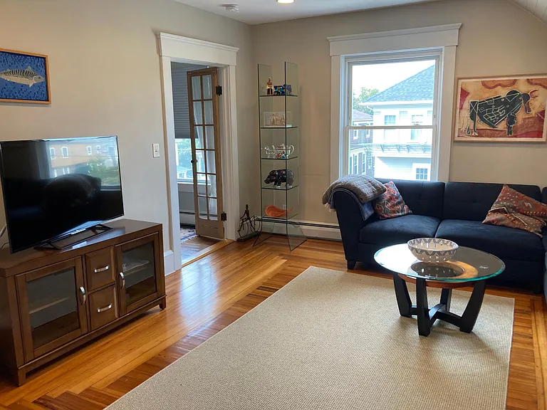 Living room looking toward primary bedroom with French doors
