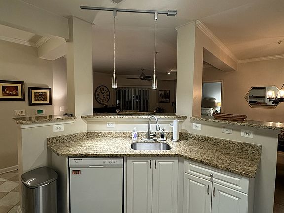 kitchen bar area facing living room and dining room