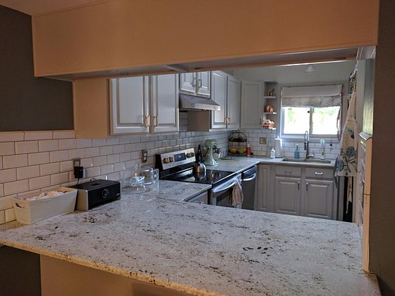 Granite countertops in kitchen. Electric Stove.