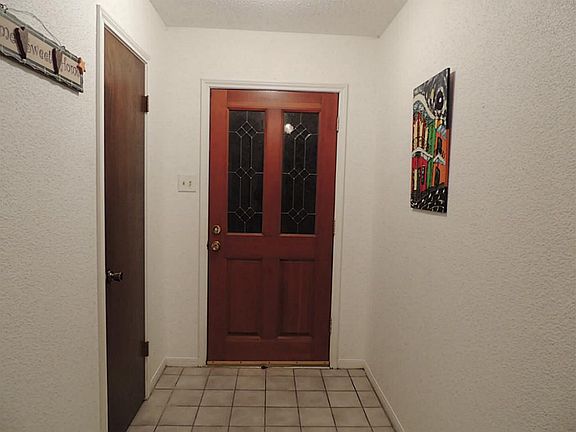 The front entry has a beautiful wood door with leaded glass and opens into a large foyer.