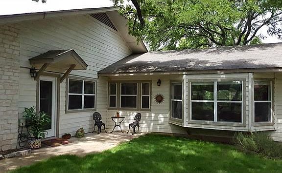 Bay window in Living room. Door at left is separate entrance into 4th Bedroom/Office/Guestroom