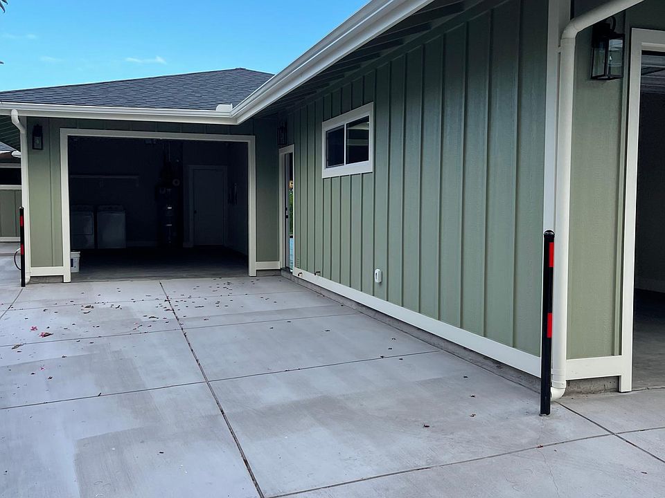 View of driveway and entry to garage