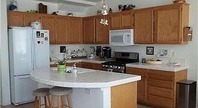 A true 'Family' kitchen.  All tiled with a small dining area in addition to the island bar.  The kitchen adjoins the family room and breakfast area.  Plenty of room for family & friends to gather & enjoy!