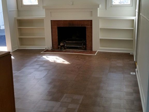 Living room with working fireplace, built-in shelves
