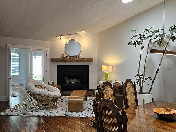 View of dining and sitting room from the kitchen. The family room is behind the papasan.