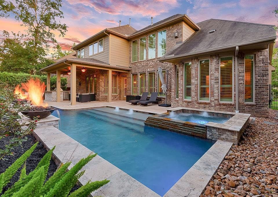 You'll never want to leave home with this stunning pool and spa, complete with fountains, fire bowls, and a summer kitchen!