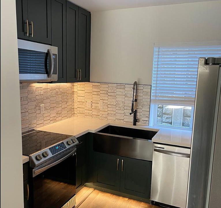 brand new kitchen with stainless steel appliances, under-mount lighting, farmhouse sink, and new soft close cabinetry