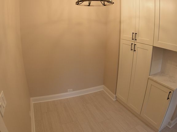 Eat-in area of kitchen with large pantry-style cabinets