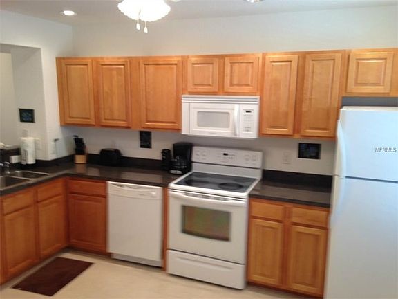 WOOD CABINETS, RECESSED LIGHTING AND CEILING FAN/LITE FIXTURE