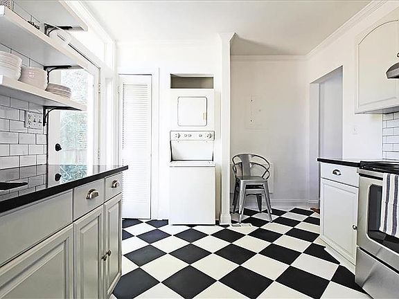 Kitchen with stainless steel appliances & full size washer and dryer in the unit