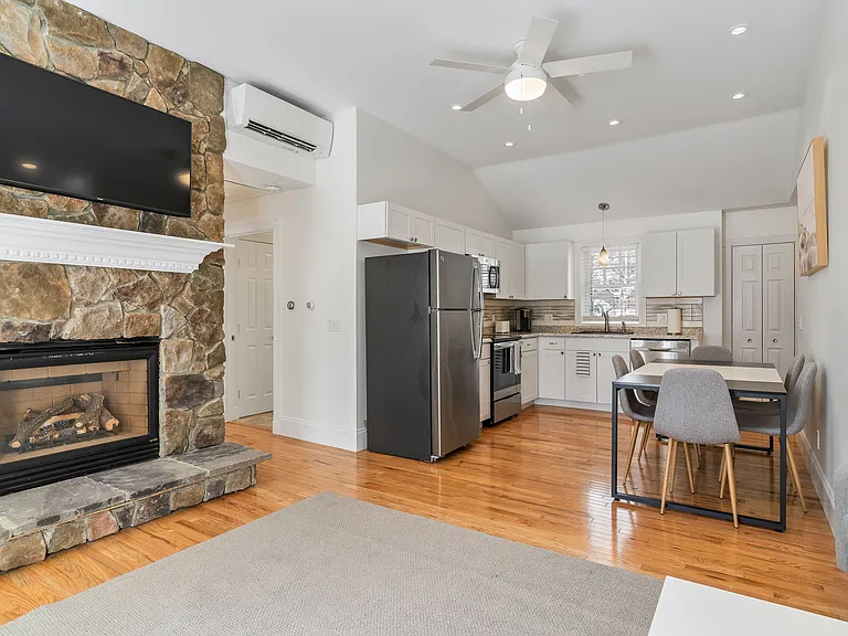 Stainless Steel Appliances, Eat-in Kitchen, Dining Space, Modern Kitchen, Hardwood Floors, Ceiling Fan, White Cabinetry, Open Layout.