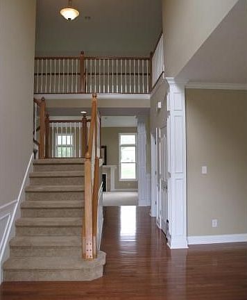 Two-Story Entry with gleaming Hardwood Floors.