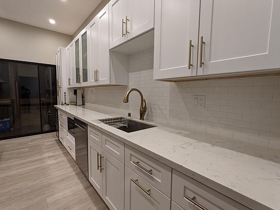 Kitchen with Delta faucet and backsplash