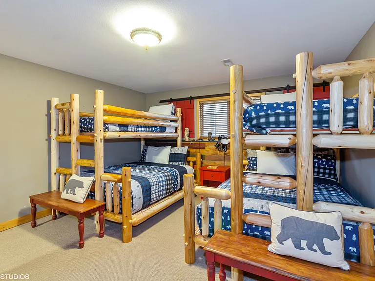 Lower level two sets of Twin XL over Full bunk beds