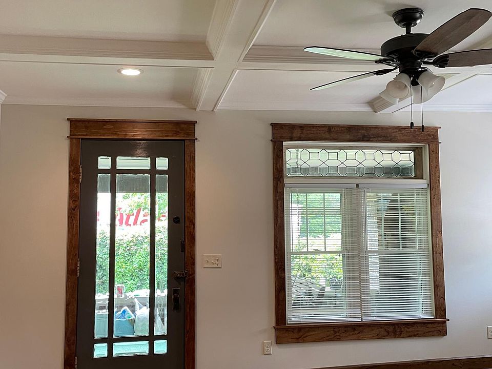 Coffered living room ceiling with fan and recessed lighting.
