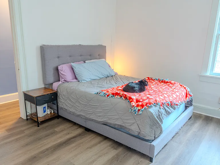 Bright and airy master bedroom with high ceilings.