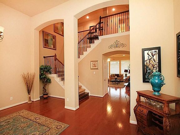 View from front entry showing wrought iron on stairway...
