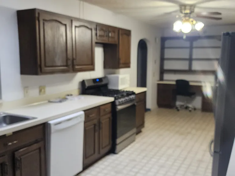 Huge Kitchen with Gas Stove and Fridge.
