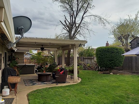 Covered patio with ceiling fan and outlets for hot tub