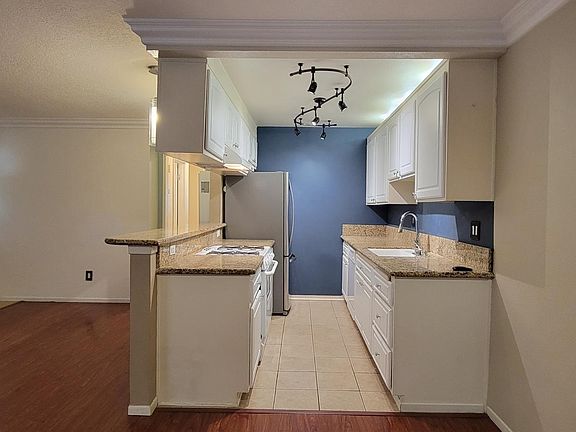 Full view of kitchen with fridge