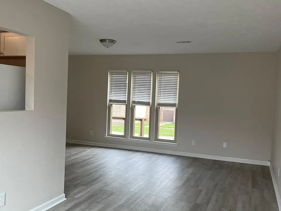 view of dining area into living room from sliding glass door to patio, vinyl flooring