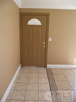Front door and ceramic floors with nice pattern.  High baseboards and paint.