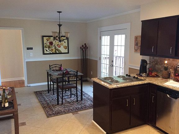 Dining area leads to back deck through well lit French doors.