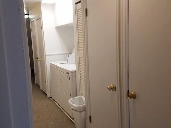washer and dryer in hallway outside of unit (This is from in