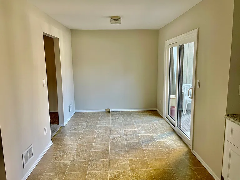 Eat-in area of kitchen. Sliding door to deck