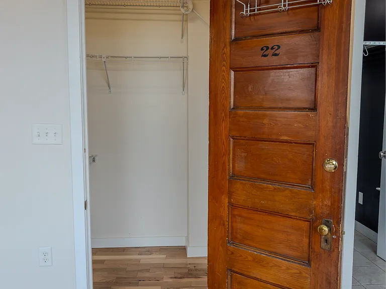 Walk-in clothing closet facing Main St, west-facing windows.