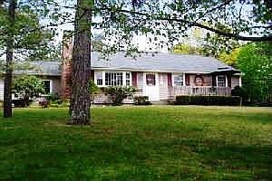 captain's village corner lot with flowering trees and evergreens, blk. top dri