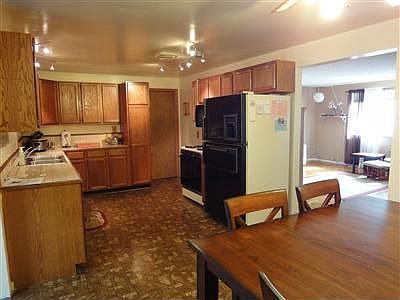 Spacious eat-in kitchen with ample oak cabinets