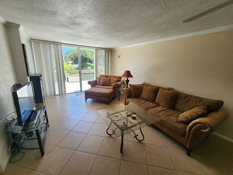 Living room looking towards the sliding glass doors that go out to your very large patio that overlooks the water.