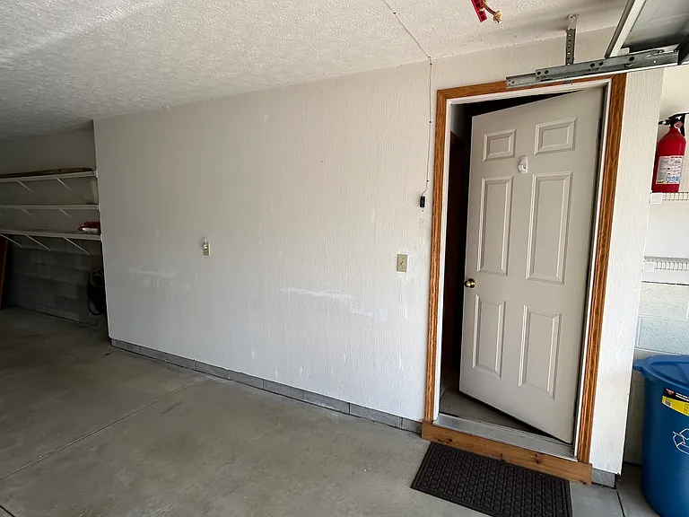 Attached tandem garage, push button on wall, keypad outside of garage, two car remotes