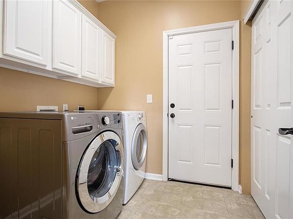 Large Laundry room with cabinets and closet