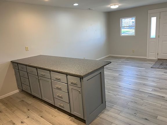 8X3 Quartz Peninsula separates the kitchen from the living area
