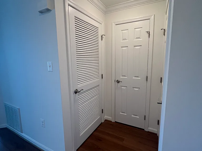 Coat closet and utility closet with stackable washer and dryer