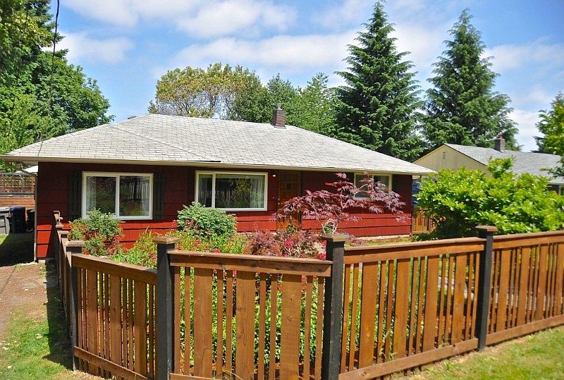 So Charming!  This lovely home welcomes you with a fully fenced exquisite garden of colorful plants and trees, flagstone path, flower borders and Maple Trees.  