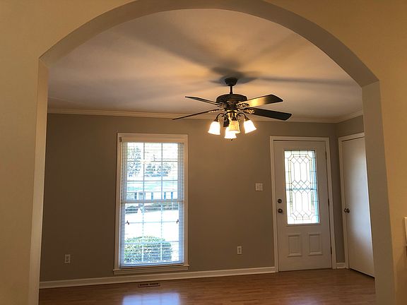 View from kitchen into family room through arched opening.