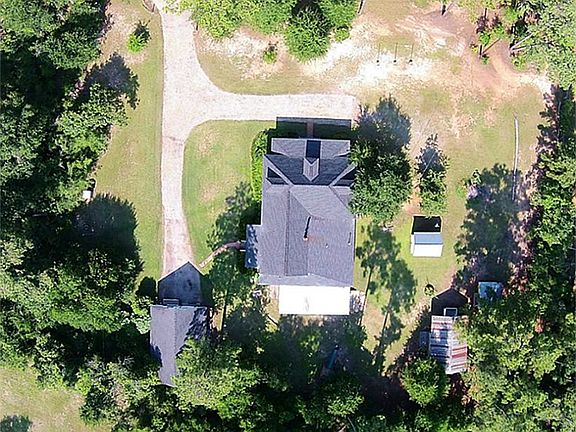 Two large workshops, garden shed & pump house, all surrounded by mature trees