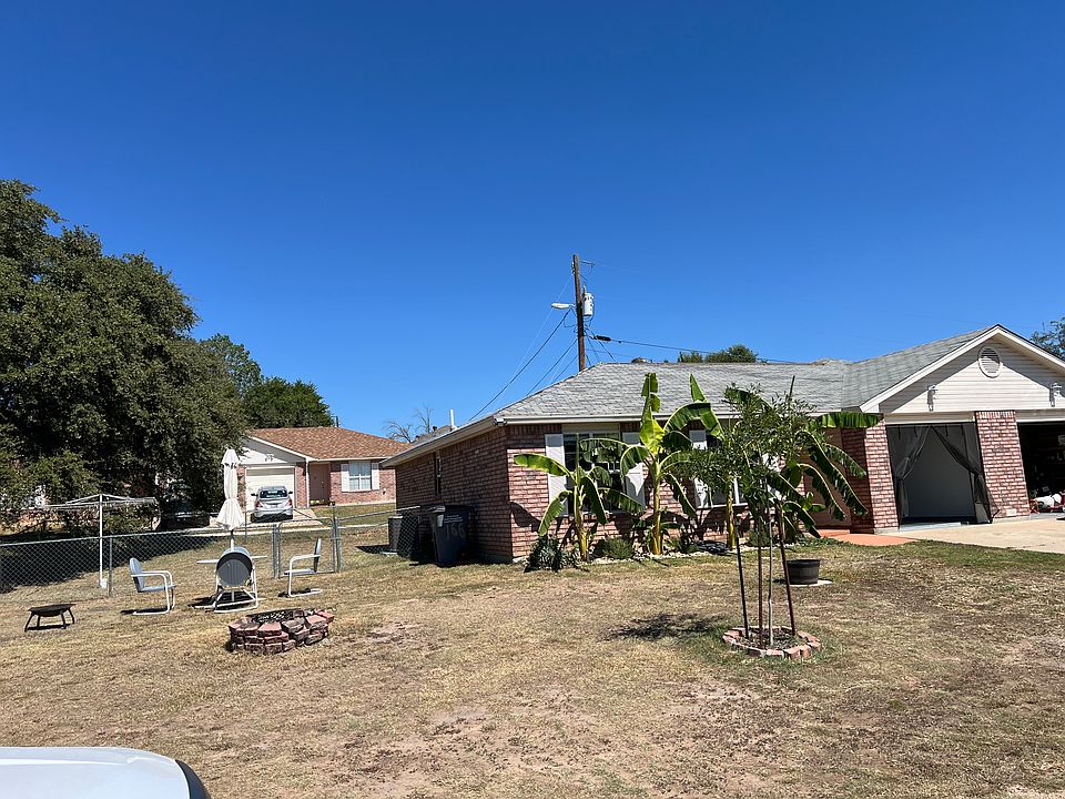 front and side yard with fire pit and extra parking